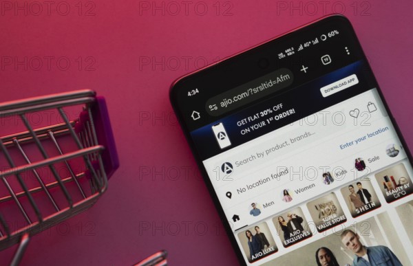 Dhaka, Bangladesh- 23 June 2025: A smartphone displaying the AJIO website with a shopping cart is