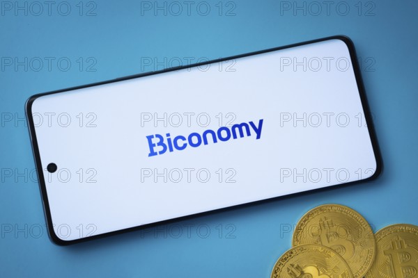 Dhaka, Bangladesh- 02 June 2025: Biconomy logo on smartphone screen near Bitcoin coin and QR code