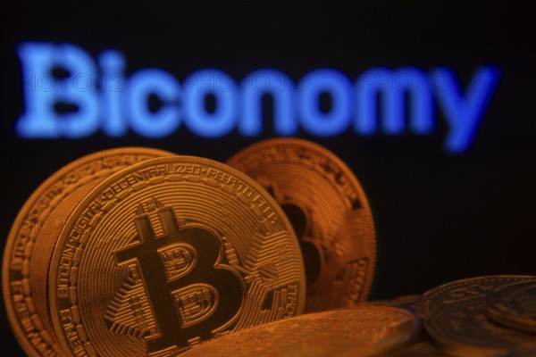 Dhaka, Bangladesh- 03 Sep 2025: Close-up of Bitcoin coins with the Biconomy logo visible on a