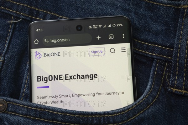 Dhaka, Bangladesh- 15 June 2025: A smartphone displaying the BigONE web interface peeks out of a