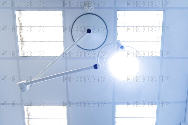Bright operating or treatment room, view of medical examination light and ceiling lighting from the