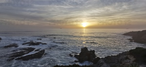 A breathtaking sunset over a rocky and wild coast, hiking the Fisherman's trail, Rota Vicentina,