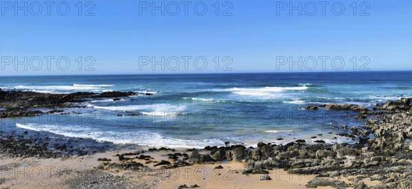 Hiking the fishing trail, Rota Vicentina, Clear blue sky with waves in blue water hitting rocky