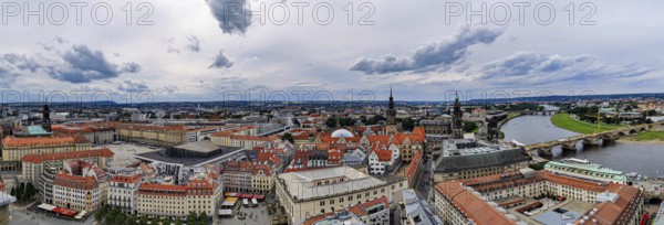 City panorama of Dresden, with river, bridge and distinctive architectures under cloudy sky,