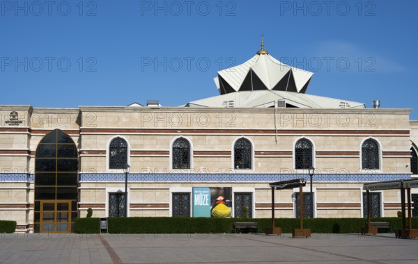 Modern building with a distinctive roof and numerous rows of windows, Irfan Medeniyeti Arastirma ve