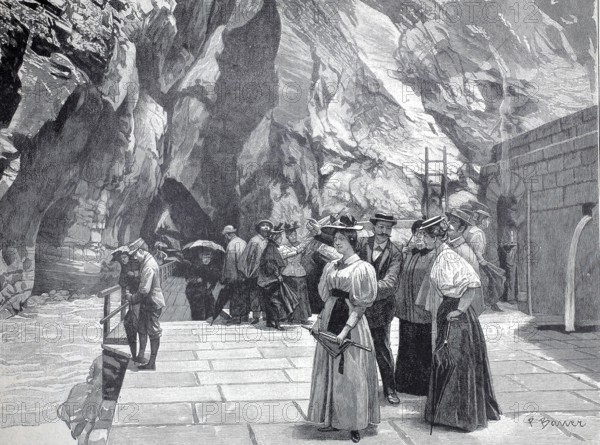 Day trippers at the end of the Tamina Gorge in front of the entrance to the spring, part of the