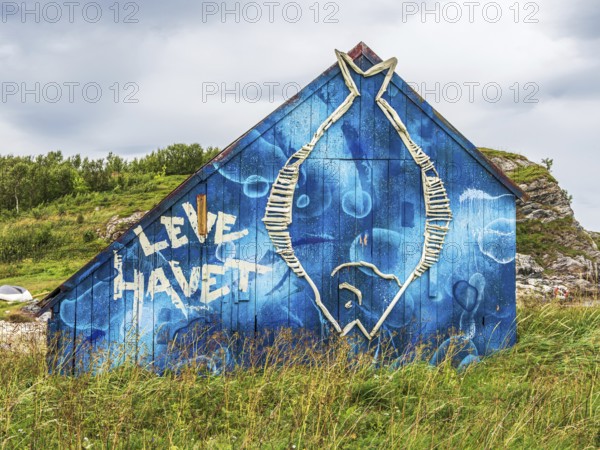 Painted colorful boathouse, text 'live the sea', island Kvaloya, Norway