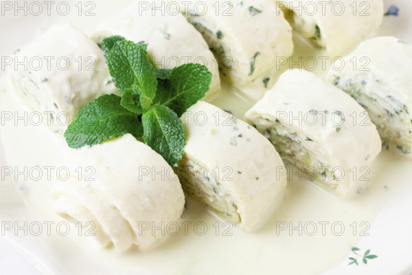 Gebjalia, a traditional Megrelian dish, cold appetizer of cheese with mint, Georgian cuisine, on a