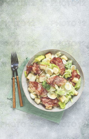 Caesar salad with fried bacon, quail eggs, homemade, no people