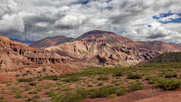 Wide mountain landscape with rock walls and clouds in the sky, the landscape and colorful rock