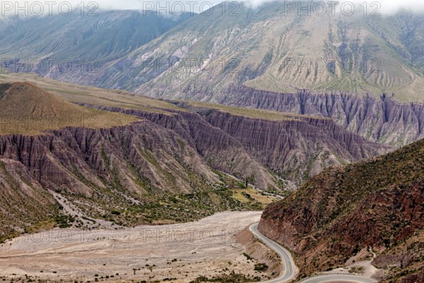 Deep valley with steep slopes in a bare and dry desert landscape, the landscape and colorful rock