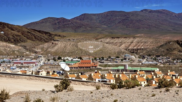 View of a small village in a hill and mountain landscape with central antenna, San Antonio de los
