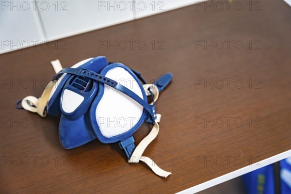 Respirator mask on a dusty workbench, highlighting essential ppe for automotive and industrial