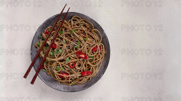 Udon noodles, with shimeji mushrooms, vegetables, in sauce, with sesame seeds, green onions, Asian