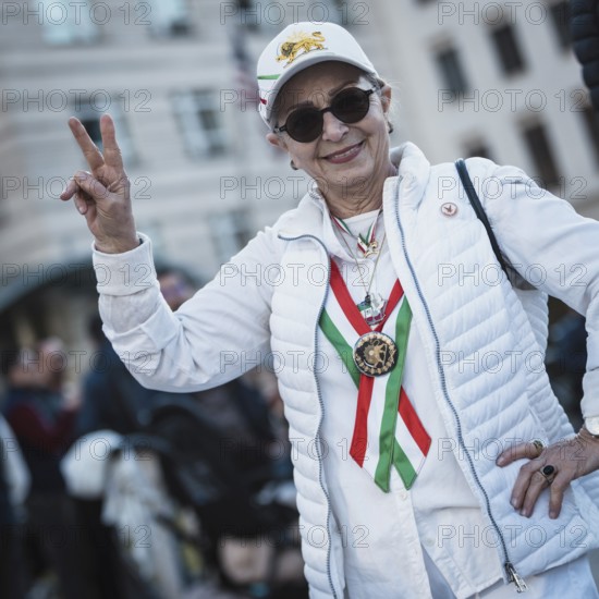 A participant in the colors of Iran at the demonstration by exiled Iranians under the motto Freedom