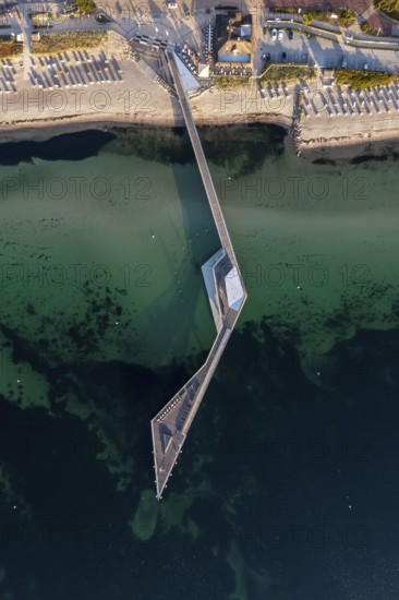 Aerial view over Seebrücke, pier and sandy beach at seaside resort Haffkrug along the Baltic Sea,