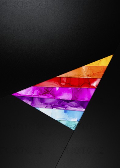 A bold triangular design featuring vibrant colors inks like orange, red, purple, and blue against a