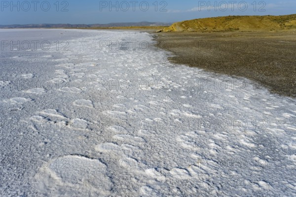 Texturally rich salt flat on the shore of a lake that ends on the horizon far away, Salt Lake, Tuz