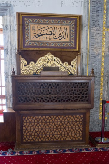 Decorated wooden shrine with Islamic script in a prayer room, minbar or mimber, preaching pulpit,