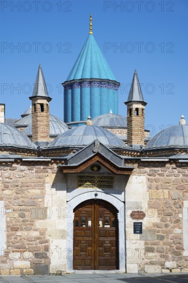 Turquoise dome on historic mausoleum nestled against a blue sky, Mevlana Museum, Mevlana, landmark,