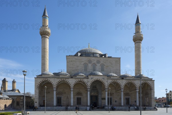 Historic mosque with two minarets and an impressive dome under clear skies, Selimiye Mosque, Konya