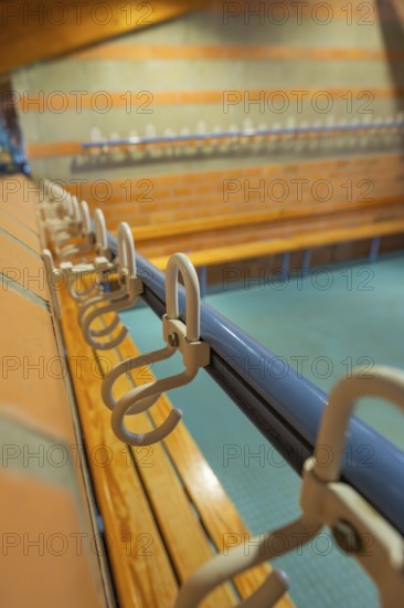 Close-up of a series of hooks in a changing room with blue tiles, Schlehengäu Grund Schule