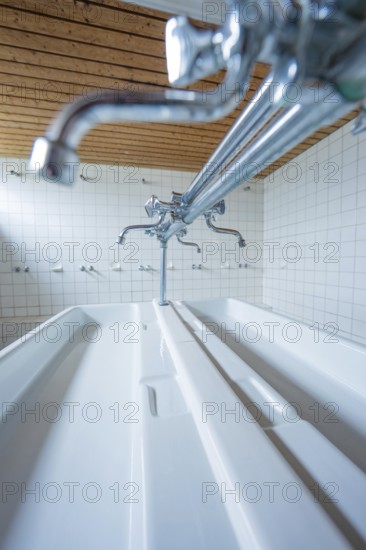 Close-up of a laundry room with silver faucets and white ceramic sinks, Schlehengäu Grund Schule