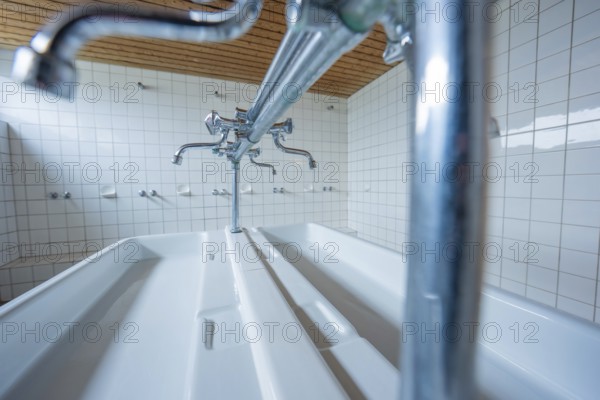 Laundry room with several taps and tile walls, modern and functional, Schlehengäu Grund Schule