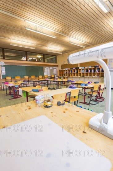 Classroom view from the teacher's desk with a view of blackboard and arranged rows of seats,