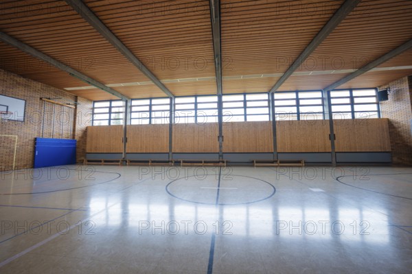 Large, empty gym with wooden floors and windows that let in natural light, Schlehengäu Grund Schule