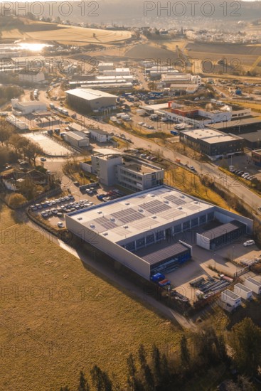 Aerial view of industrial landscape with buildings, fields and roads at sunset, Calw, Calw