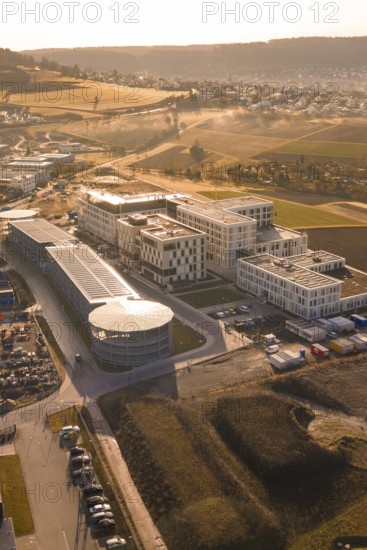Industrial complex with modern buildings in a rural area with fields, new hospital at the Calw