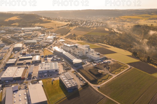 Extensive industrial area against a rural backdrop at golden hour, new hospital at Calw Health