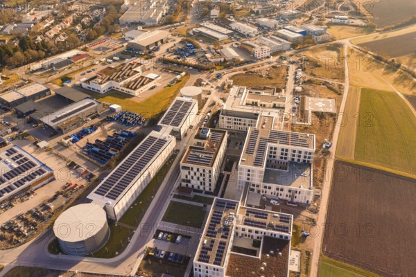 Aerial view of a modern industrial plant surrounded by city and nature, new hospital at the Calw