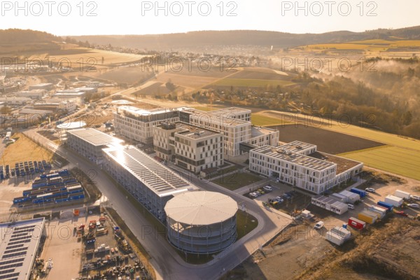 Aerial view of a large industrial area in a hilly landscape, new hospital at the Calw health