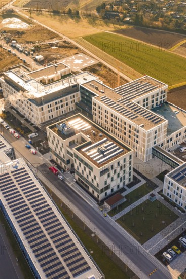 Modern architecture using solar energy in an urban facility surrounded by fields, new hospital at