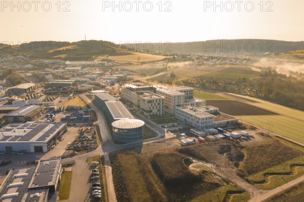 Aerial view of modern buildings in a vast rural area in the morning haze, new hospital at Calw