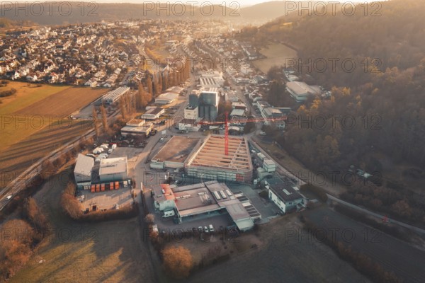 Extensive urban scene with construction crane and surrounding buildings in hilly landscape and
