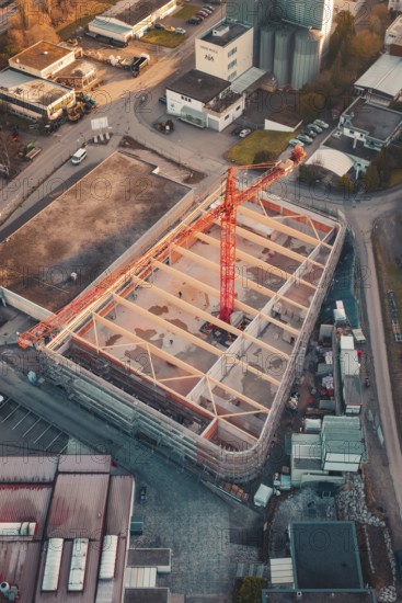 Bird's eye view of a construction site with visible building structure and construction crane at