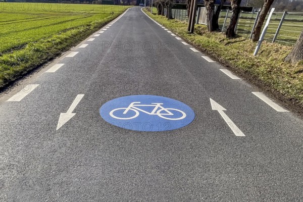 Large marking on narrow district road country road in rural area painted symbol for road signs 244