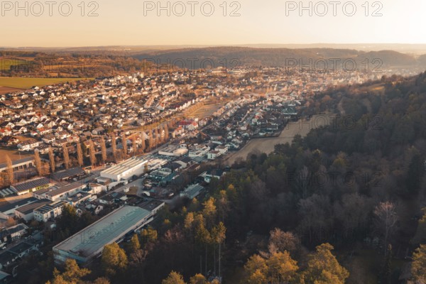 Panoramic view of a town adjacent to dense forest under evening sun, Aidlingen, Böblingen District,
