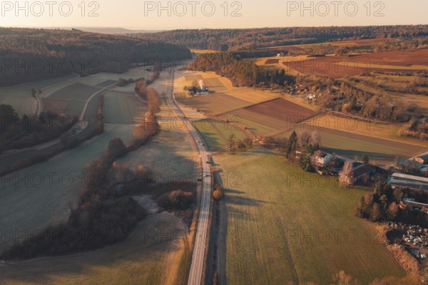 Fields and a road extending through a rural landscape under sunny skies, Aidlingen, Böblingen