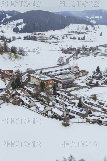 A small village in a snowy landscape with clearly visible roads and buildings, specialist clinic