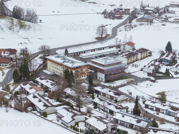 Snowy village with views of roofs and roads from above, specialist clinic for psychosomatics and