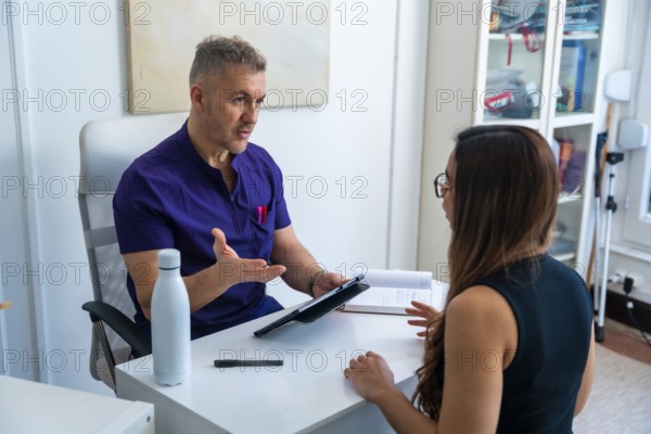 Healthcare professional explaining treatment options to a young woman during a consultation in a