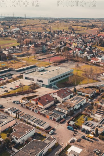 Residential area in a city surrounded by fields and trees seen from the air, Ötisheim, Enzkreis,