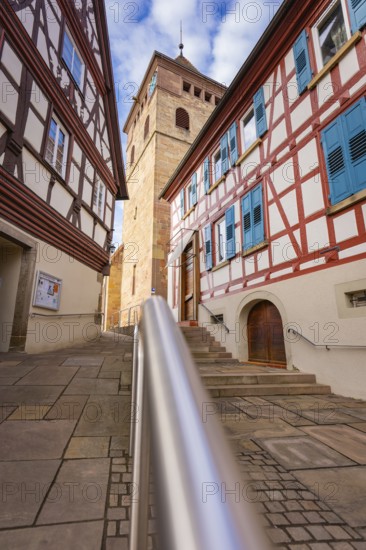 Historic half-timbered houses with church tower and stairs, sunny weather, Ötisheim, Enzkreis,