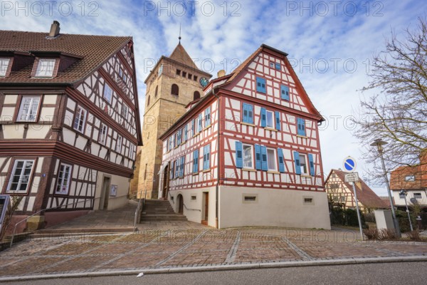 Half-timbered houses and church tower on a paved road in a historic setting, Ötisheim, Enzkreis,