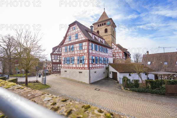 Village view with half-timbered houses and church tower under blue sky, Ötisheim, Enzkreis, Germany