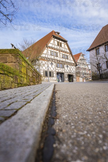 Street scene with traditional half-timbered house and tiled roof under sky, Ötisheim, Enzkreis,